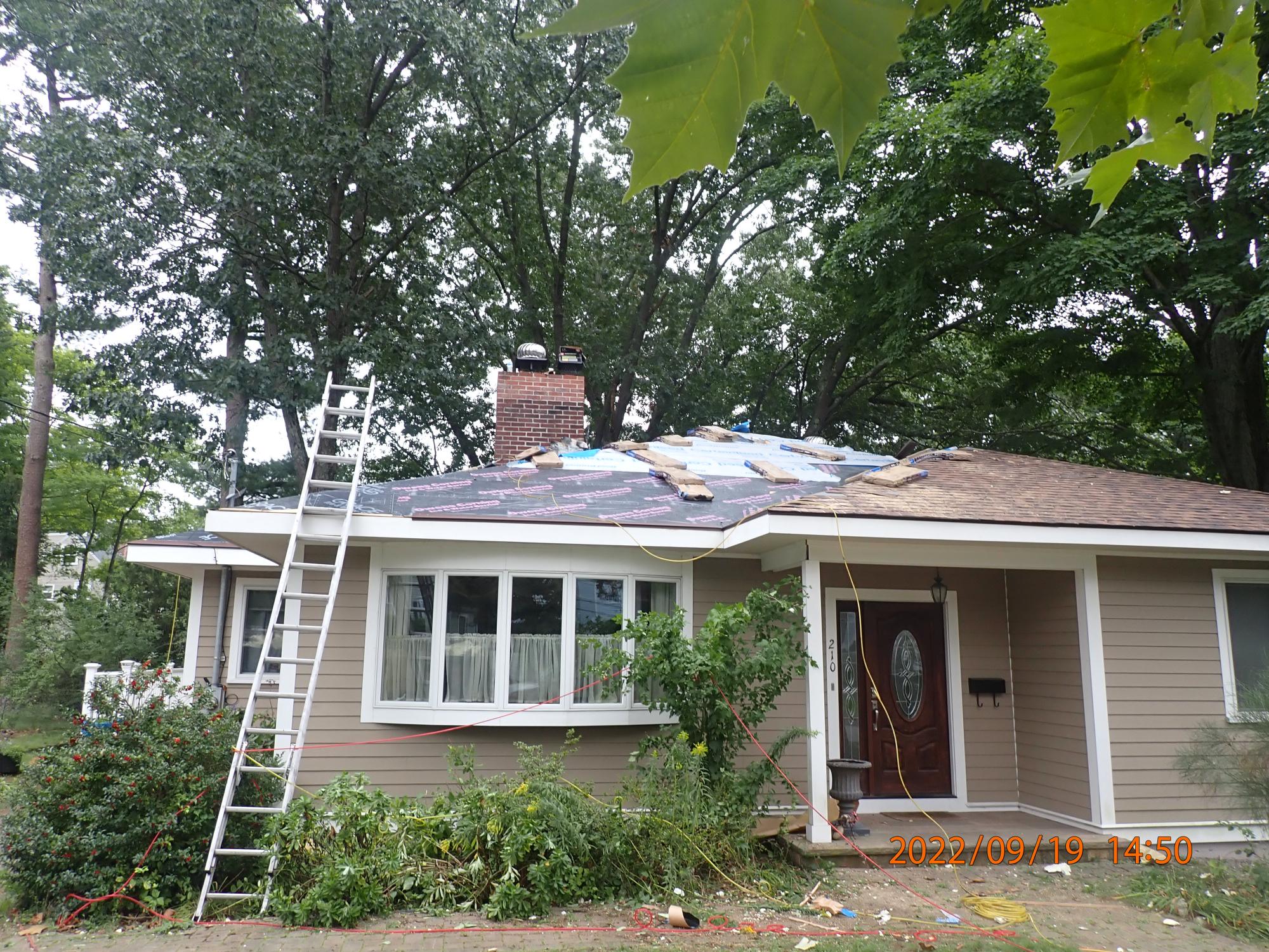 team actively installing new roof