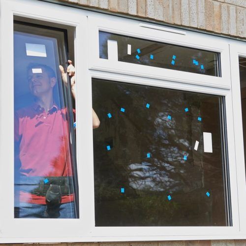 Construction,Worker,Installing,New,Windows,In,House