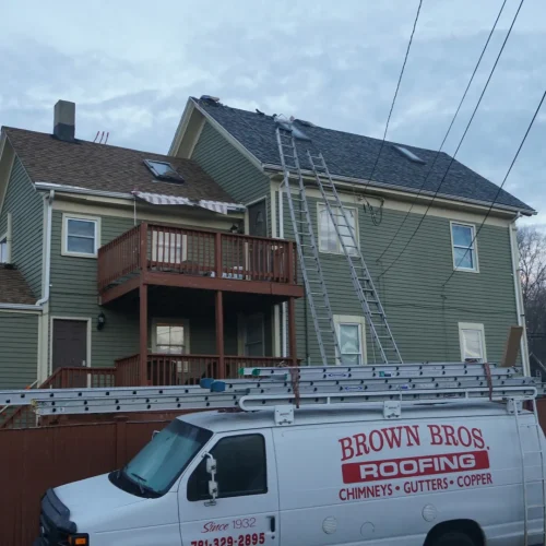 brown bros roofing truck parked at home roofing installation project